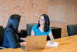 Two women meeting in an office space.